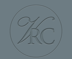 Embossed logo with the stylized letters "KRC" inside a circular border on a blue-gray background.
